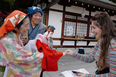 thumbnail view of Faces of Study Abroad - Bree Cloud - Japan - Fall 2019 - Ebisu - Meeting the puppet version of the Japanese god of fishing, Ebisu, with local puppeteers at Mondoyakujin temple