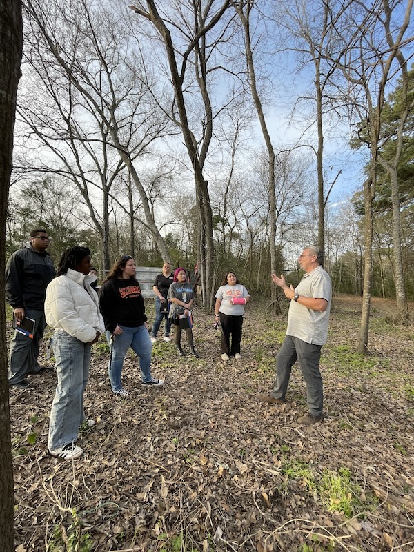 CHSS skills challenge participants tour the Good Shepherd Mission property with the organization's director, Monte Robinson.